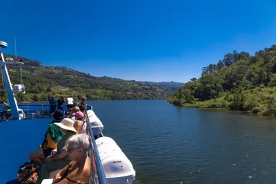 Start in porto, bus to régua, cruise the douro valley past terraced vineyards and through river locks, with lunch onboard. includes pickup and local guide.