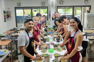 Get hands-on in a phuket thai cooking class, visit a bustling local market, taste exotic fruits, and enjoy your meal—includes pickup and all ingredients.