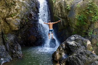 Feel the wild side of el yunque with a muddy hike, two waterfalls, cliff jumps, and a natural waterslide—includes san juan pickup and local guide.
