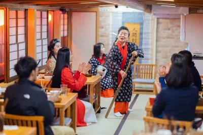 Float past tokyo tower and rainbow bridge on a yakatabune cruise, enjoy sukiyaki dinner, live shamisen music, and city lights. includes pickup and drinks.