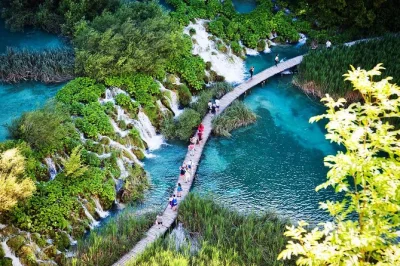 Feel the mist at plitvice lakes on your way from split to zagreb. includes guided walk, boat & train ride, and all transfers. book with pickup and local guide.