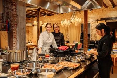 Feel the buzz of barcelona’s boqueria market, cook paella with hofmann-trained chefs, and share catalan tapas in a historic studio—includes wine and all ingredients.