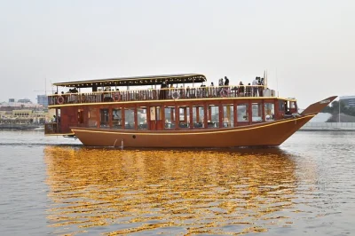Float past old souks and glittering towers on a dubai creek dhow cruise with buffet dinner, family-friendly dance shows, and optional pickup for a relaxed evening.