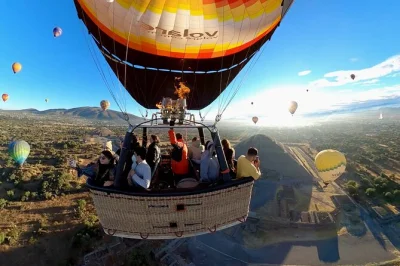 Wake early in mexico city for a sunrise hot air balloon over teotihuacan, with mariachi breakfast, round-trip pickup, and a traditional toast after landing.