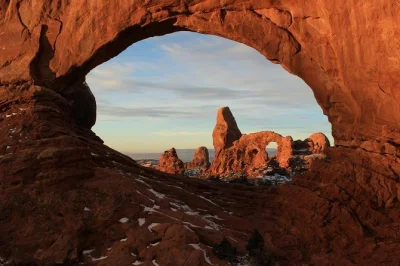 Feel the crunch of red dust underfoot, spot dinosaur tracks, and hike to tower arch on this moab 4x4 adventure—includes pickup, local guide, and cold drinks.