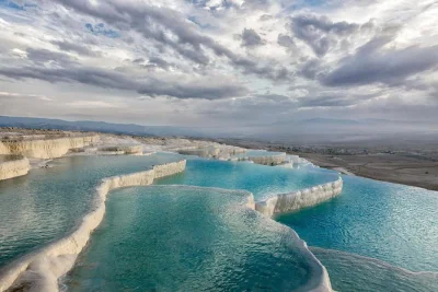 Start your pamukkale day trip from izmir, explore ancient hierapolis, relax in the travertine thermal pools, and enjoy a local lunch. includes hotel pickup.