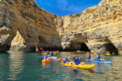 Start your day at praia de benagil, paddling through sea caves and golden arches with a small group. includes kayak, life jacket, waterproof pouch, and local guide.