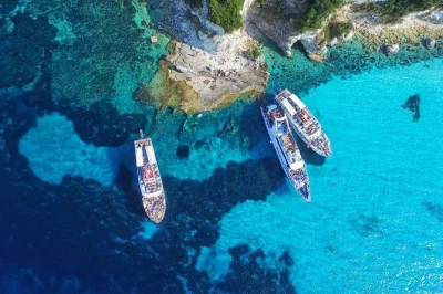 Feel the sea breeze on a corfu to paxos & antipaxos boat tour, swim in blue caves, stroll gaios village, and enjoy guiding in multiple languages. includes all fees.