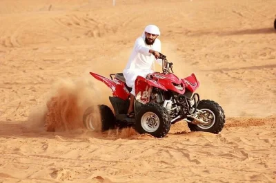 Feel the rush of dubai’s lahbab red dunes on a desert safari with quad biking, camel rides, live shows, and a bbq dinner—includes hotel or airport pickup.