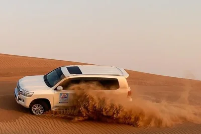 Feel the thrill of dubai’s lahbab red dunes in a private 4x4, try sandboarding, enjoy a bbq dinner with live shows, and relax under desert stars. includes pickup.