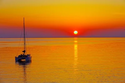 Feel the sea breeze on a santorini sunset catamaran cruise, swim at red & white beaches, enjoy a greek bbq with drinks, and relax with hotel transfers included.