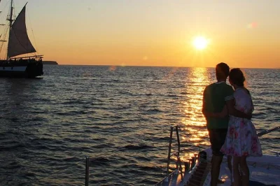 Feel the sea breeze on a santorini sunset catamaran cruise, swim near red & white beach, enjoy a bbq meal on board, and sip wine as the caldera glows. includes hotel pickup.