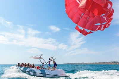 Feel the rush of parasailing from albufeira marina, flying high above the algarve coast with a small group and pro crew. includes safety gear and boat ride.