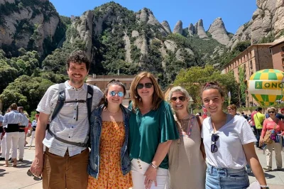 Feel the spirit of montserrat on a private day trip from barcelona with hotel pickup, la moreneta access, local flavors at the farmers’ market, and a short hike.