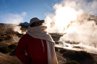 Before sunrise, watch steam rise at el tatio geysers in the atacama. includes hotel pickup, breakfast, flamingo lagoon stop, and a visit to machuca village.