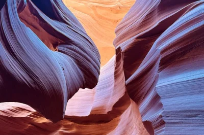 Step into arizona’s lower antelope canyon with a navajo guide, see shifting light on sculpted walls, and climb steel ladders—entry & permit included.