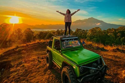 Feel the chill before dawn as you ride a private jeep up mount batur, watch sunrise over bali, explore black lava fields, and enjoy breakfast with hotel pickup.