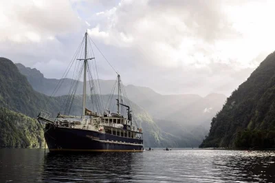Wake up surrounded by doubtful sound’s misty silence, spot dolphins from a classic sailing scow, kayak sheltered coves, and share stories over dinner. includes transfers & meals.