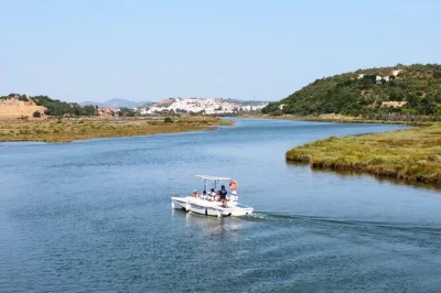 Glide quietly up the arade river to silves on an eco-friendly solar boat, with live stories from your captain and free time to explore the medieval city. includes pickup.