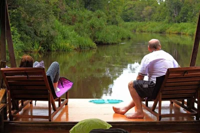 Wake up to the sounds of borneo’s rainforest, cruise by kelotok boat, spot orangutans at camp leakey, and share stories with fellow travelers. includes meals and local guide.