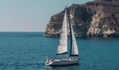 Relaxed santorini sailing cruise with swimming at red & white beach, seafood bbq, greek wine, and caldera views. hotel pickup included. book now!