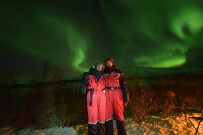 Chase the northern lights near tromso in a small group, with campfire snacks, warm drinks, and local guide pickup. includes winter suits and souvenir photos.