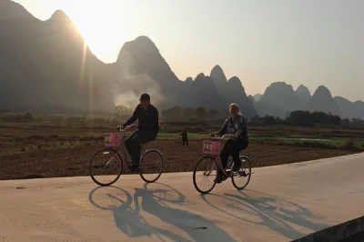 Bike through yangshuo’s villages, cruise the li river by bamboo raft, and stroll west street with a local guide. includes hotel pickup and lunch.